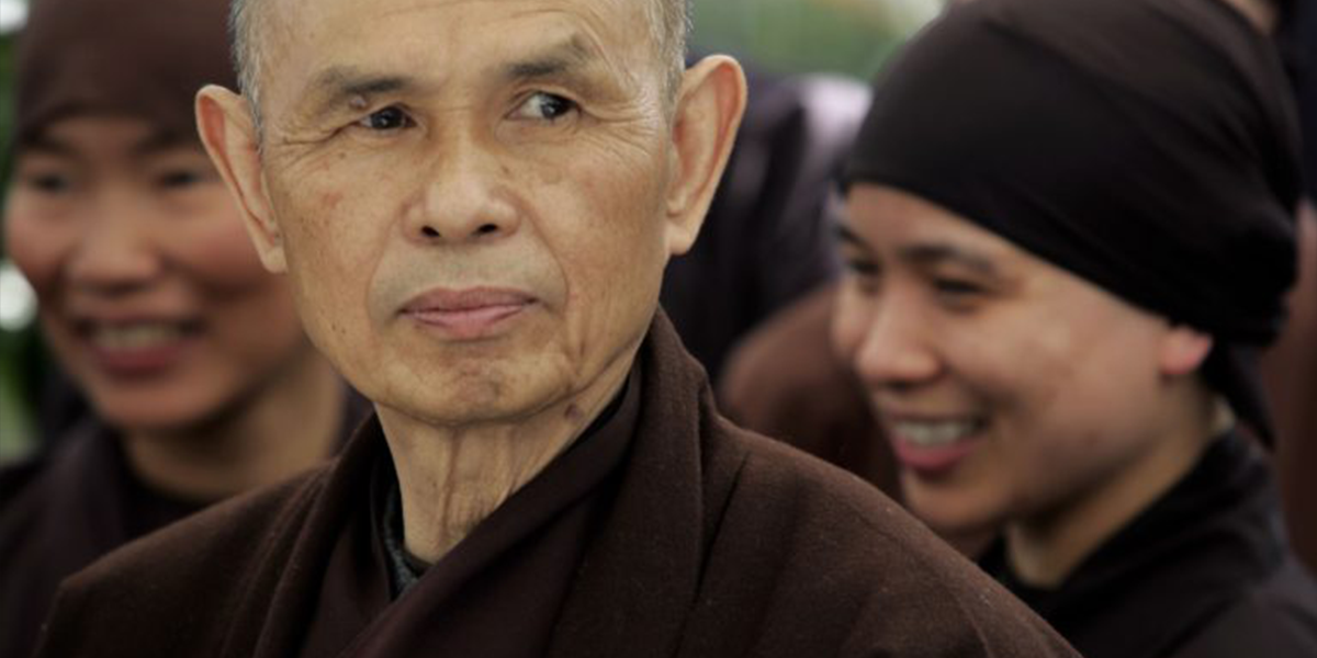 Serene face of a Buddhist monk gazing over his left shoulder.